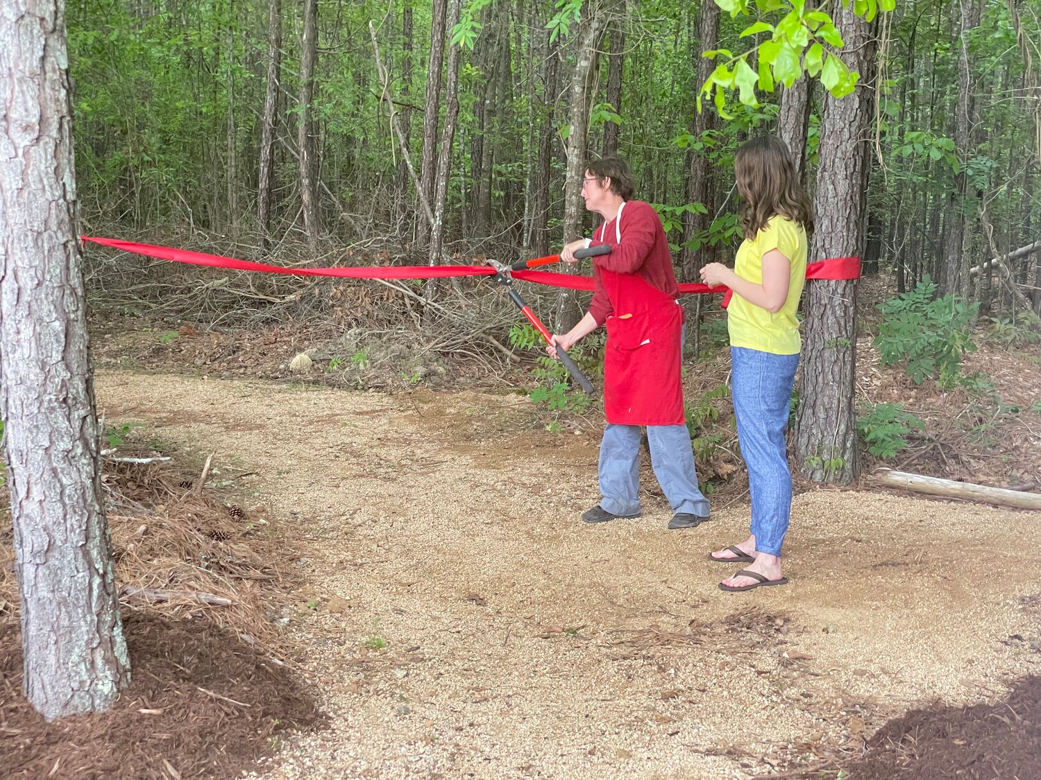 Marianne Maschal and Dr. Janice Giles, principal at North Chatham Elementary School, cut the ribbon on the new Jaguar Trail on Saturday.